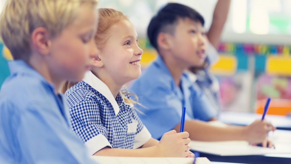 Group of children listening to the teacher.