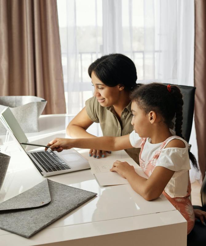 Mother Teaching Daughter Computer Skills