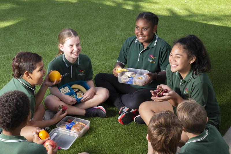 Children In A Circle Enjoying Healthy Lunches
