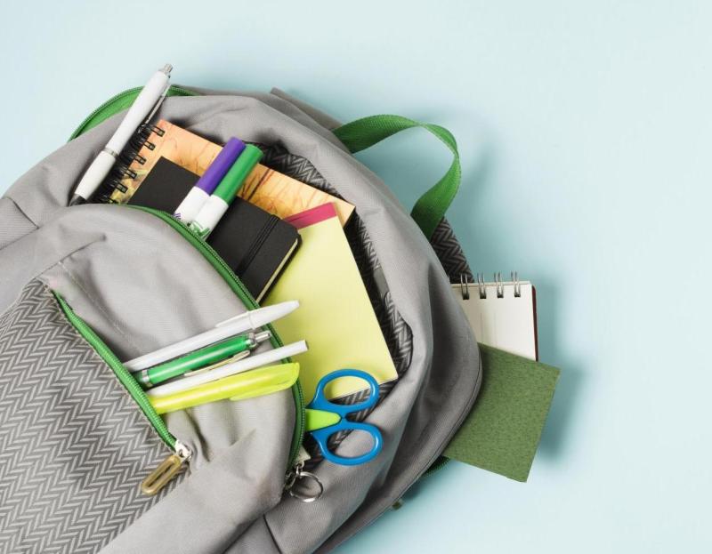 Opened Backpack With School Supplies
